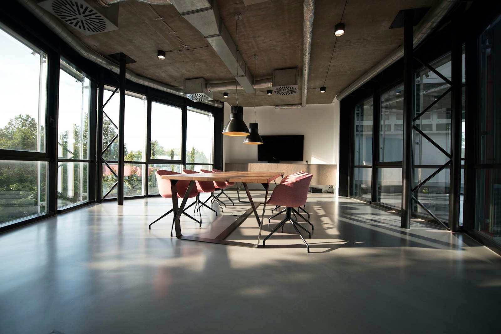 A light-filled creative workspace with timber tables and plants